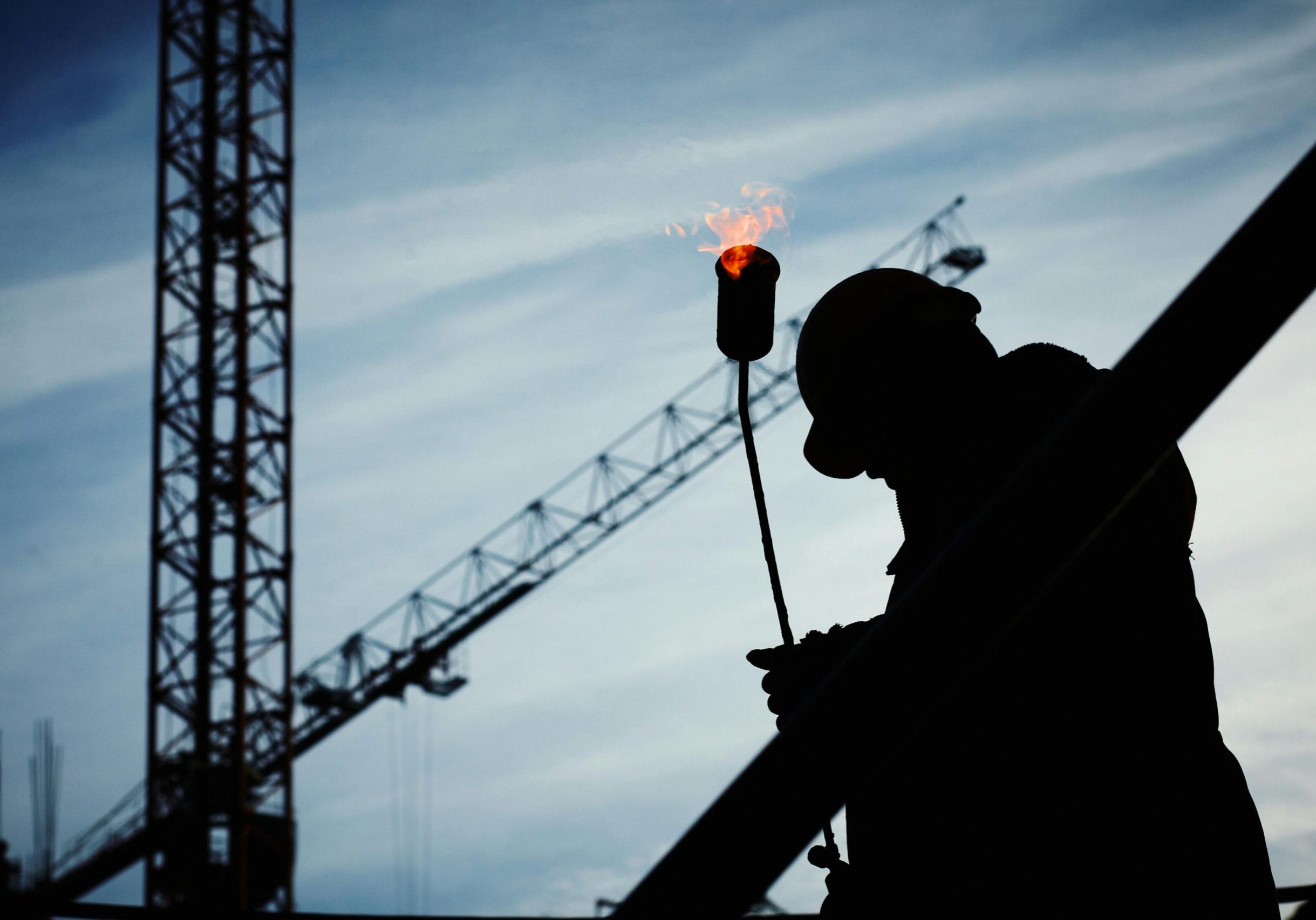 Silhouette of Man Holding Flamethrower